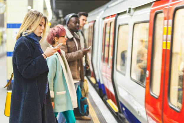 A commuter at a UK railway station